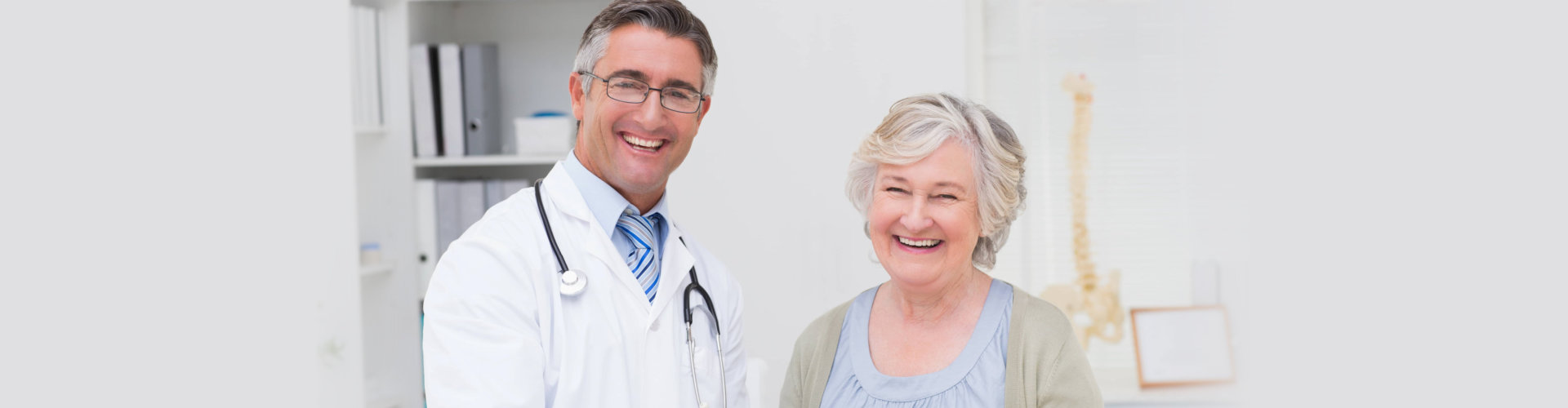 portrait of happy male doctor and female patient