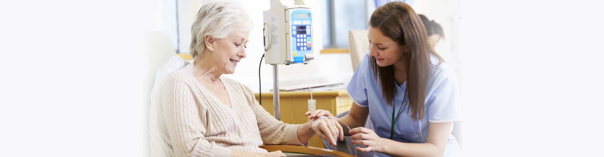 senior woman undergoing chemotherapy with nurse