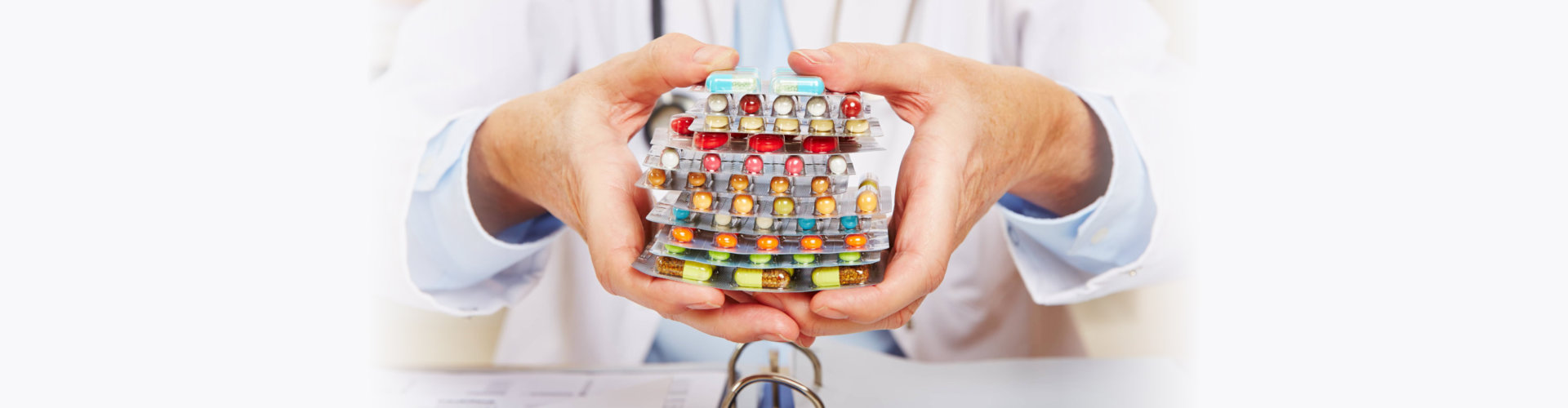 doctor holding many different colorful pills